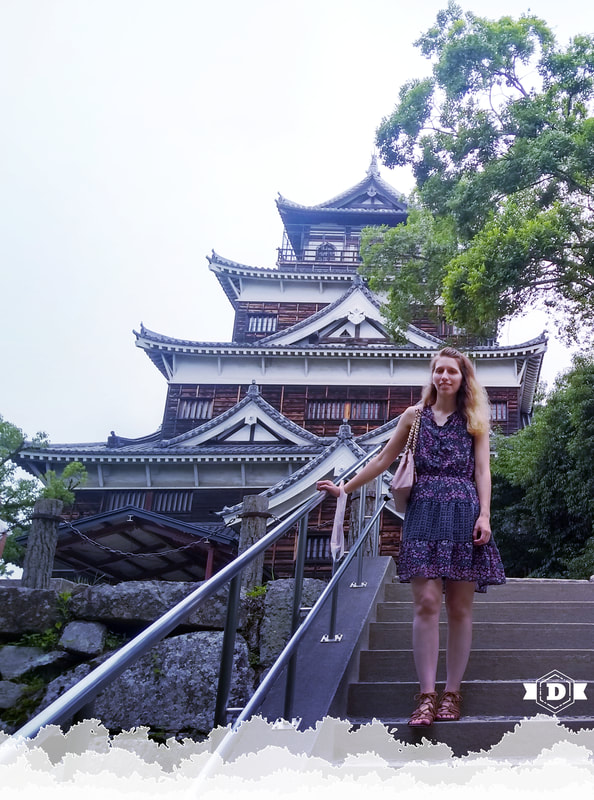 The Designbrarian standing in front of a Japanese castle